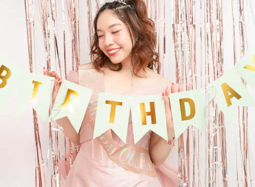Birthday banner held by woman